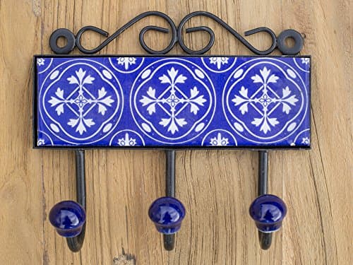 Three metal hooks with ceramic tile.Traditional Indian design.